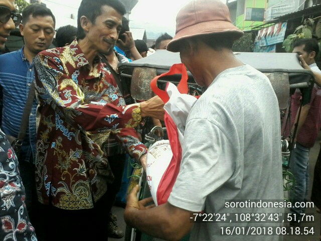 Wakil Ketua DPRD Kota Banjar, Nana Suryana, tampak ikut membagikan bantuan paket sembako Presiden RI Jokowi kepada warga di pasar tradisional Kota Banjar, Selasa (16/1/2018). 
